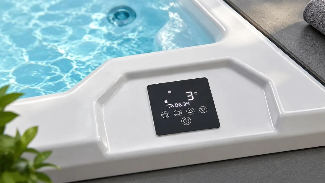 Digital temperature and timer interface Close up view of the digital touchscreen control panel mounted on the white acrylic tub rim