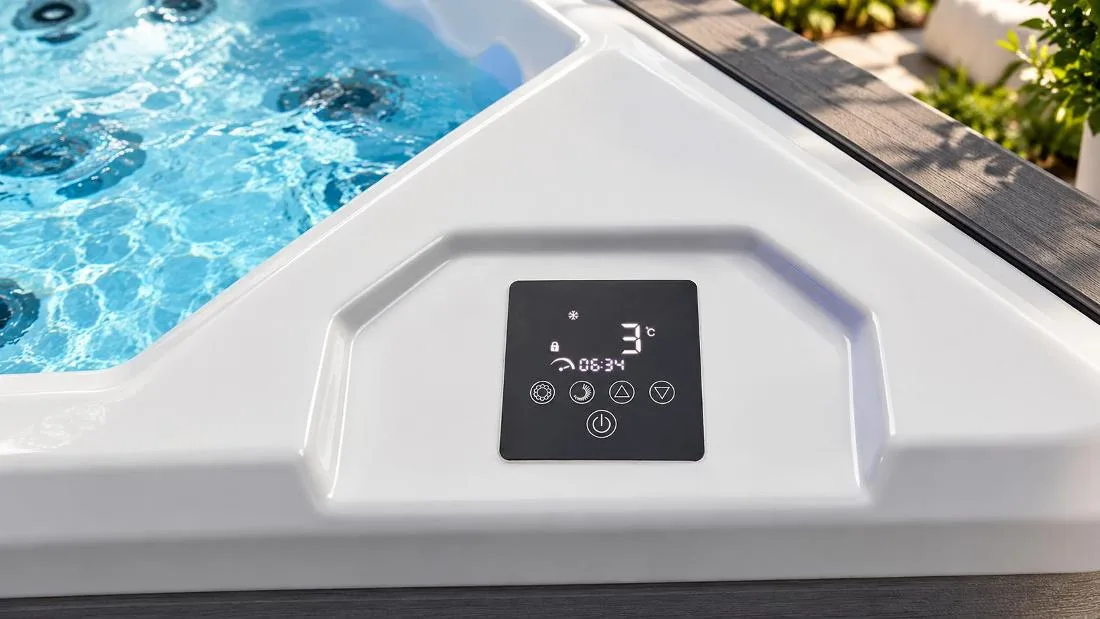 Digital Temperature and Session Timer Display Close-up top-down view of the built-in digital touch control panel on the smooth white acrylic tub ledge. The square black glossy display shows illuminated white readouts including a 3°C temperature display, snowflake cooling icon, timer showing 06:34, lock status, and five round touch icons along the bottom for settings, timer, temperature adjustment arrows, and power.