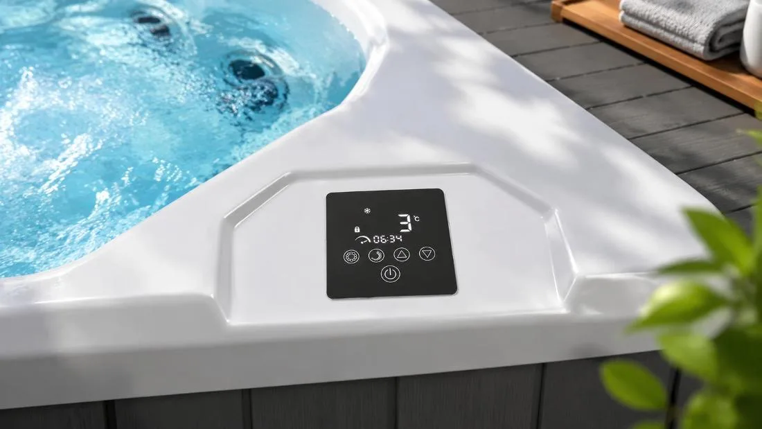 Digital Touchscreen Control Interface Close-up top-down view of the built-in digital touch control panel on the smooth white acrylic tub ledge