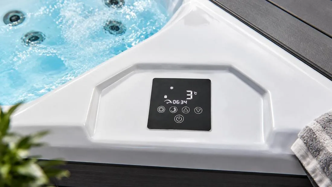 Digital Touchscreen Temperature Controller Close-up top-down view of the flush-mounted digital touchscreen control interface embedded into the smooth white acrylic tub rim