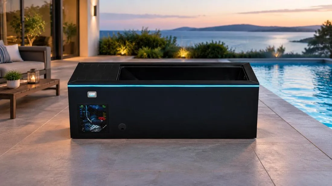 Black Cold Plunge Tub with LED Perimeter Lighting Front-facing horizontal eye-level studio shot of the black OF-CP01 cold plunge tub against a pure white backdrop. A bright cyan-blue LED strip illuminates the upper seam below the top deck rim, with the Ocean Future logo badge and a louvered ventilation grille visible on the left side of the matte black cabinet.