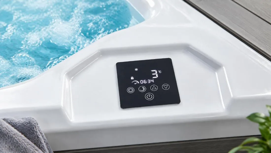 Digital touchscreen control panel on cold plunge tub Close-up top-down view of the flush-mounted digital touchscreen control interface embedded into the smooth white acrylic tub rim